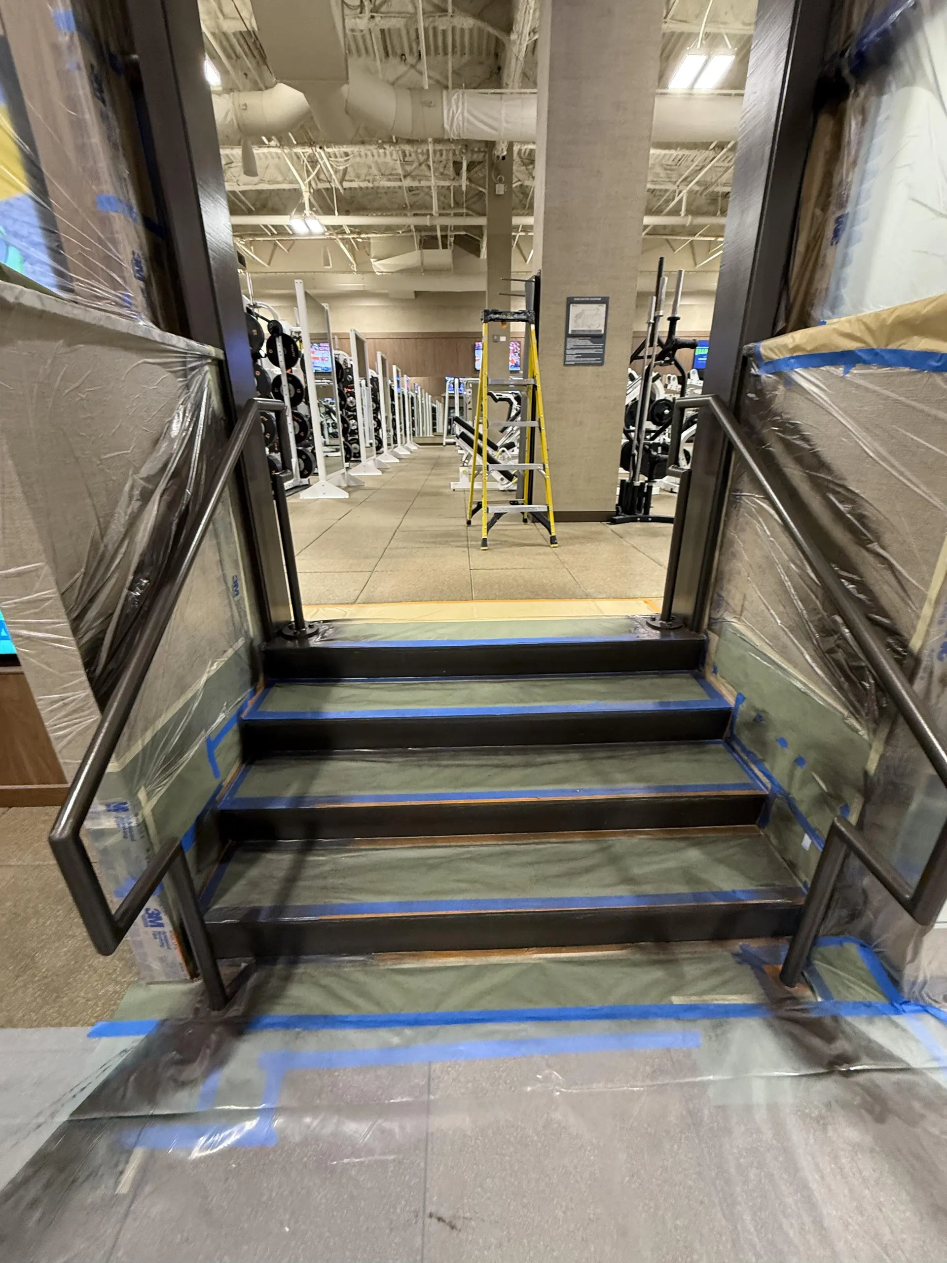 Protected stairs and railings during a commercial gym repaint