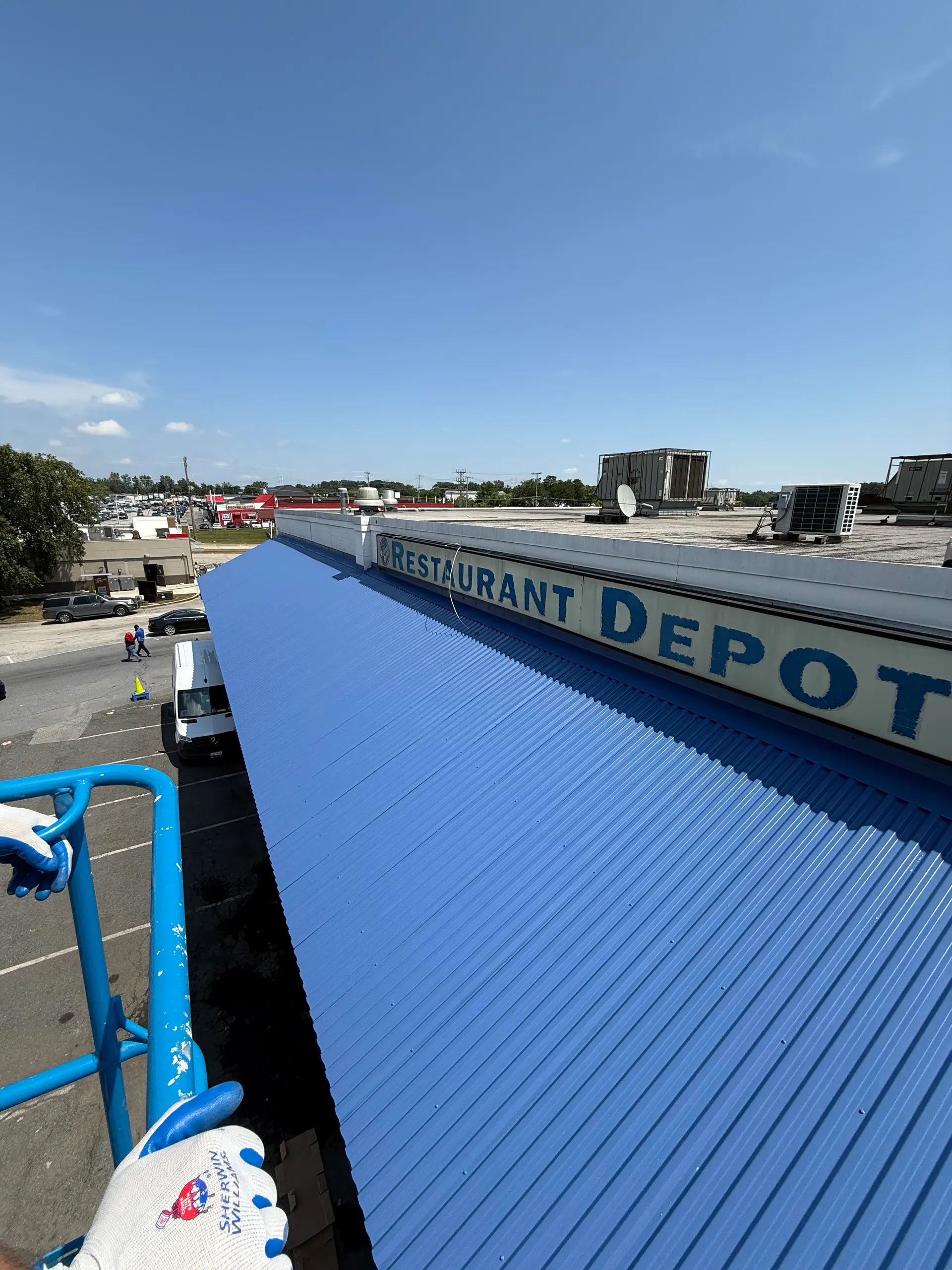 Commercial awning and sign painting from an aerial lift