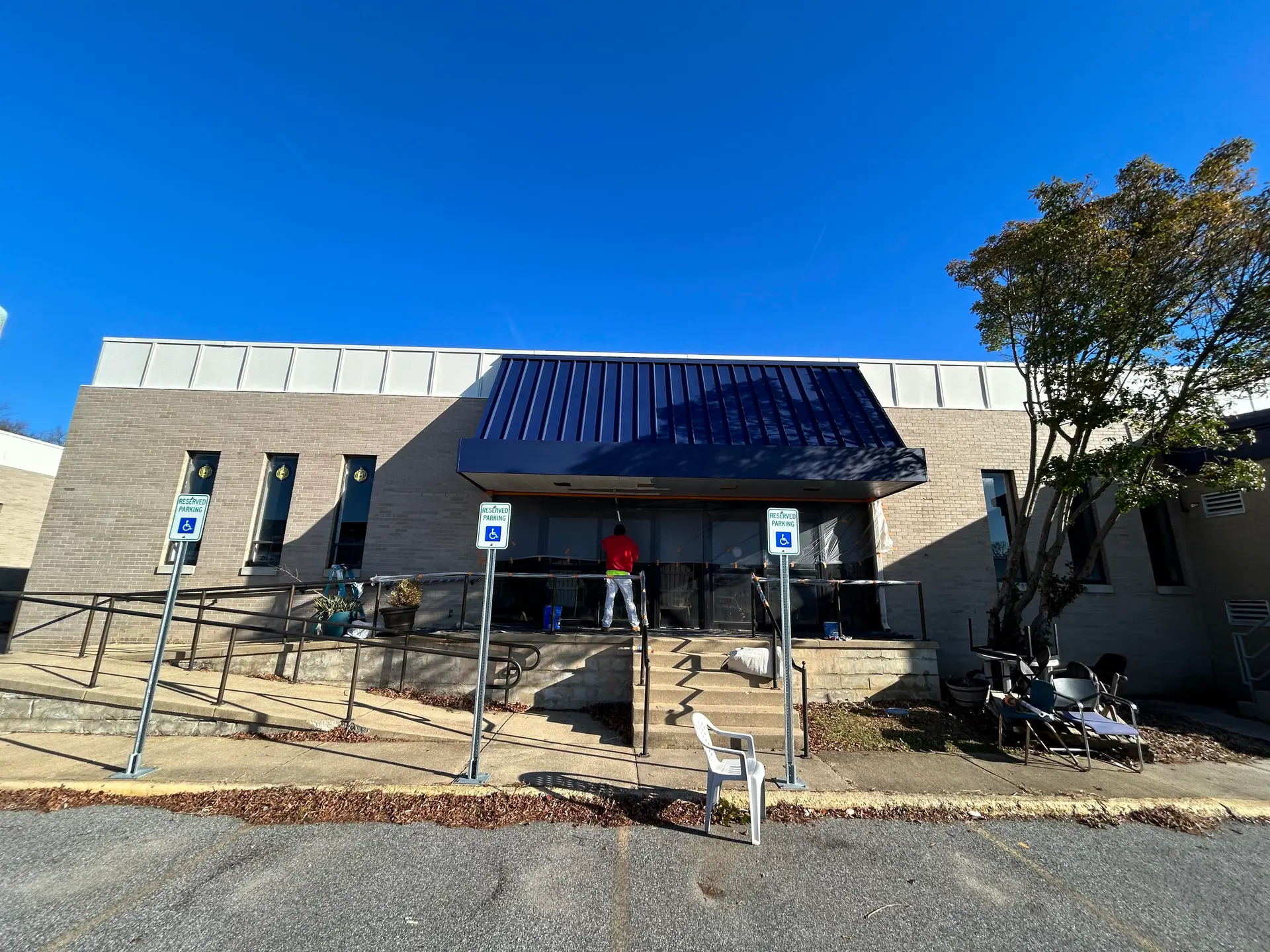 Commercial office exterior with a newly coated navy awning