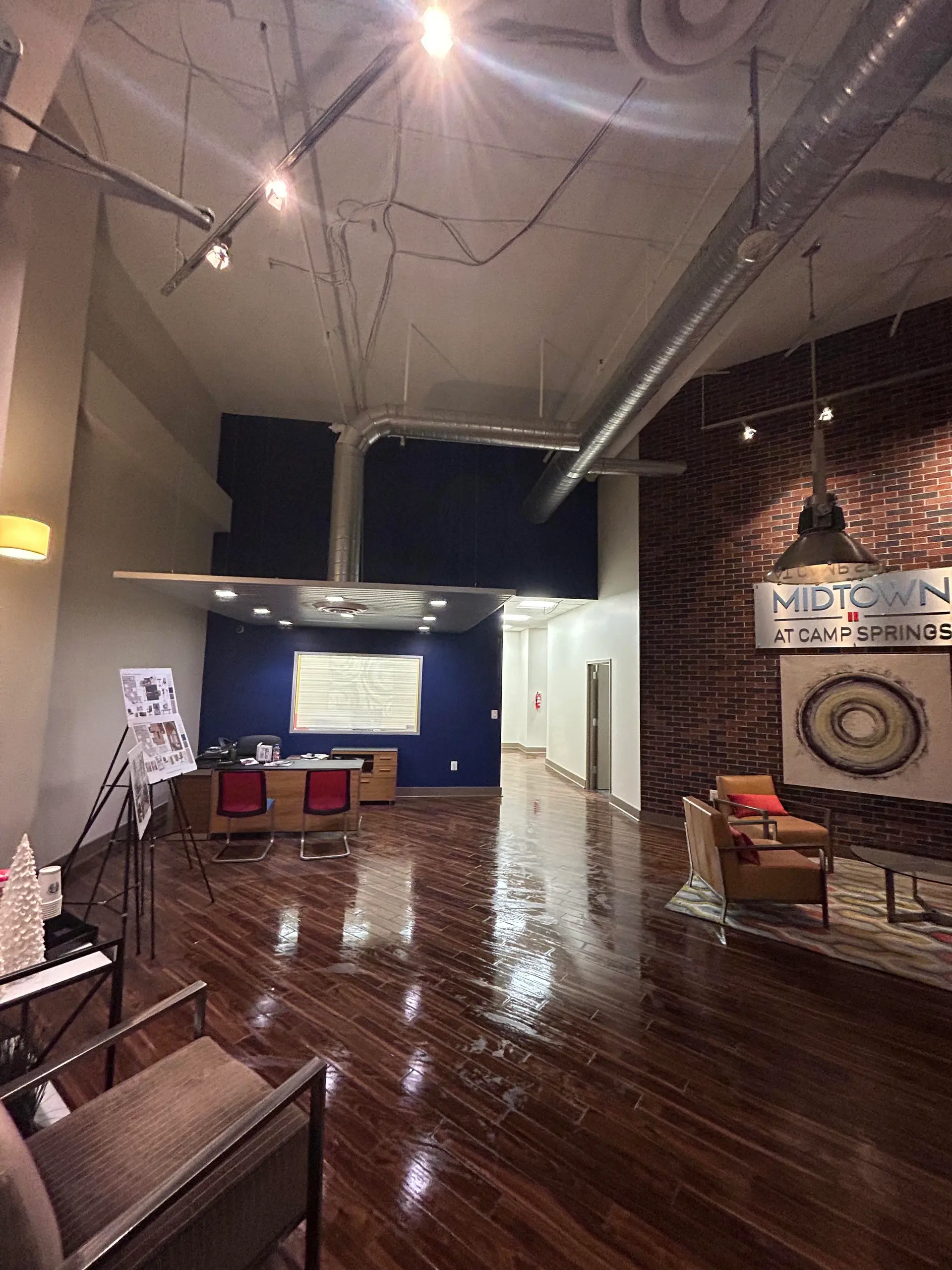 Finished commercial lobby with brick, navy, and industrial ceiling