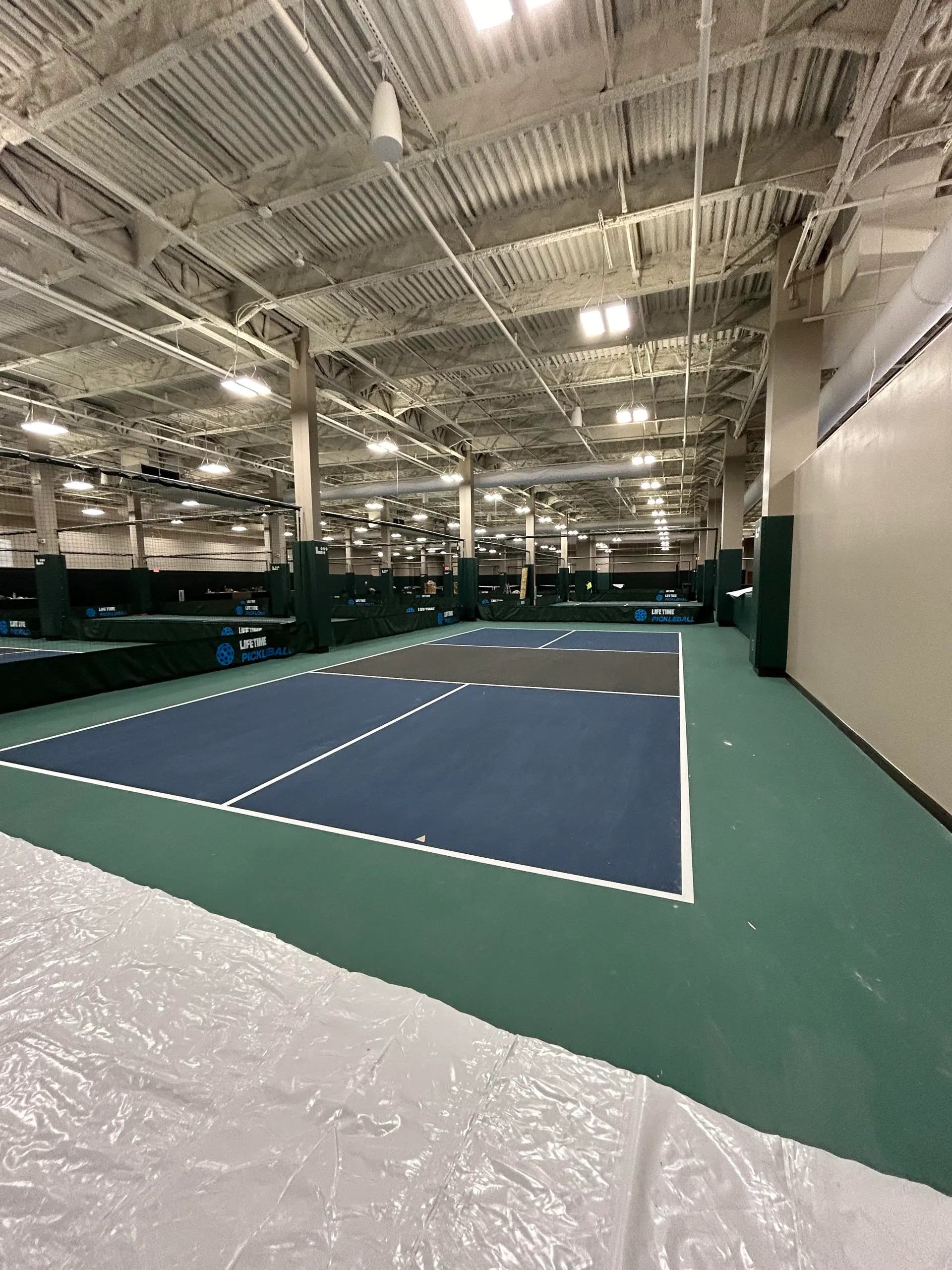 Liquid applied sports court flooring in a commercial facility